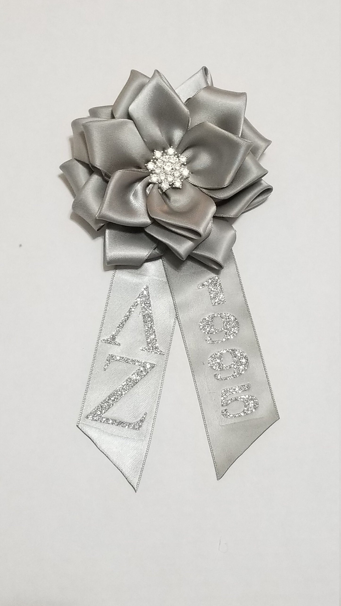 Silver anniversary corsage with detachable tail