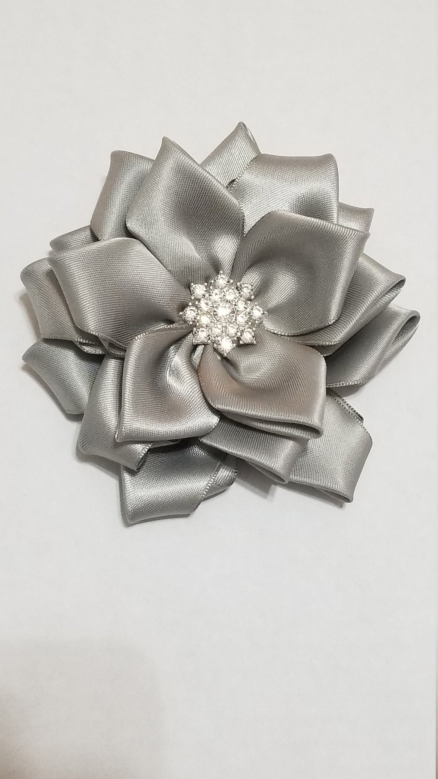 Silver anniversary corsage with detachable tail