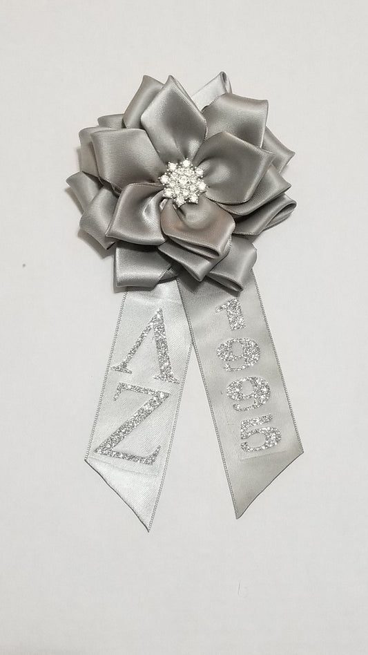 Silver anniversary corsage with detachable tail